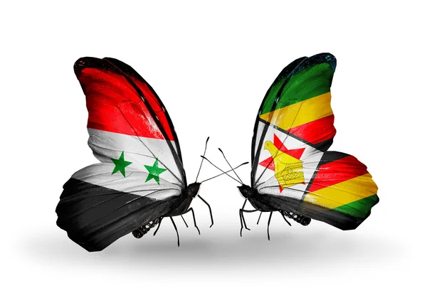 Vlinders met Syrië en zimbabwe vlaggen op vleugels — Stockfoto
