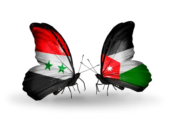 Borboletas com bandeiras da Síria e Jordânia em asas — Fotografia de Stock