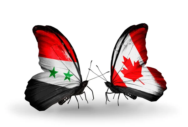 Papillons avec drapeaux Syrie et Canada sur les ailes — Photo