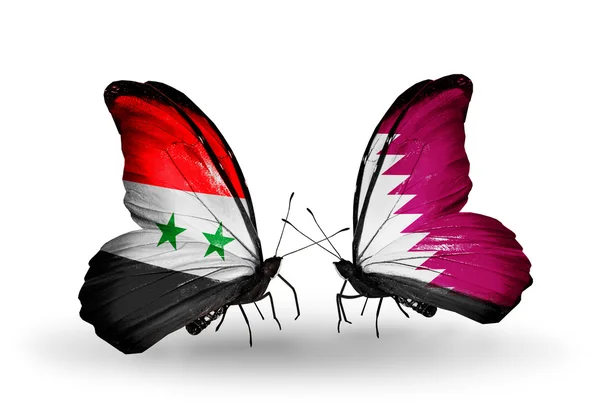 Butterflies with Syria and Qatar flags on wings — Stock Photo, Image