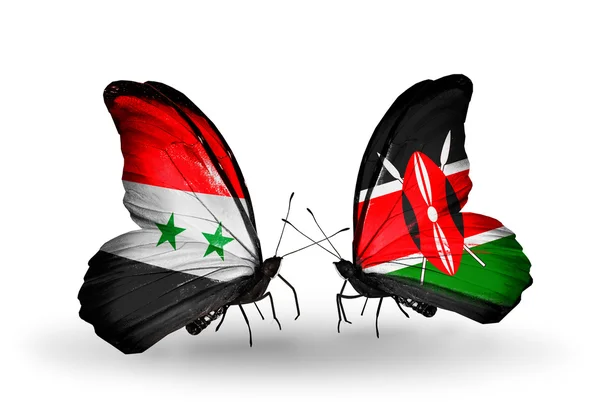 Kelebekler kanat kenya ve Suriye bayrakları ile — Stok fotoğraf