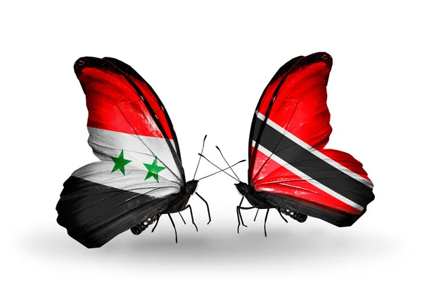 Borboletas com bandeiras da Síria e Trinidad e Tobago em asas — Fotografia de Stock
