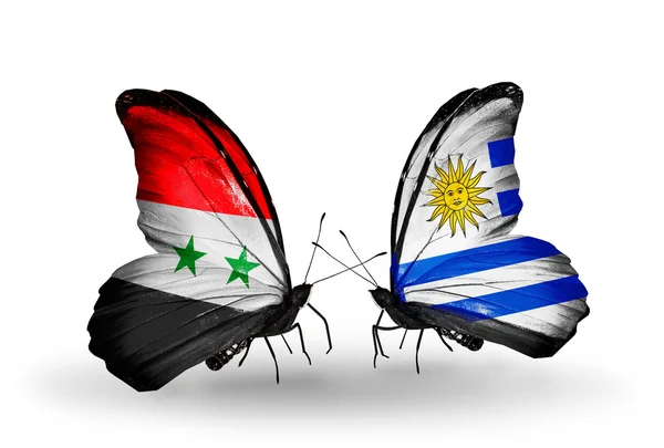 Butterflies with Syria and Uruguay flags on wings — Stock Photo, Image