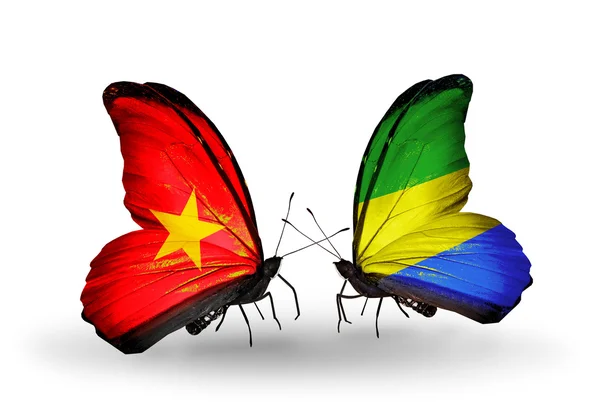 Mariposas con banderas de Vietnam y Gabón en alas —  Fotos de Stock