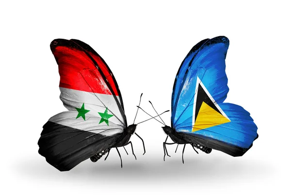 Fjärilar med Syrien och saint lucia flaggor på vingar — Stockfoto