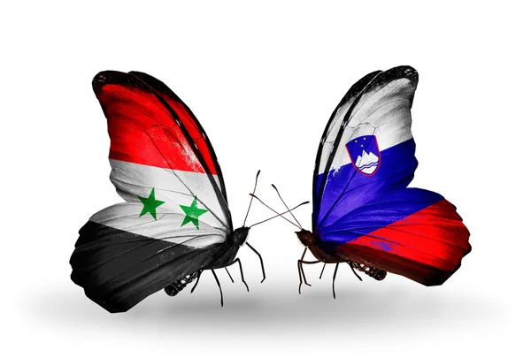 Butterflies with Syria and Slovenia flags on wings — Stock Photo, Image