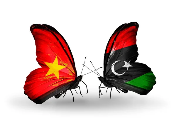 Две бабочки с флагами Вьетнама и Ливии — стоковое фото