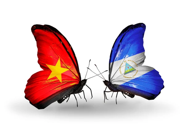 Dos mariposas con banderas de Vietnam y Nicaragua —  Fotos de Stock