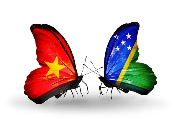 Twee vlinders met vlaggen van vietnam en de Salomonseilanden — Stockfoto