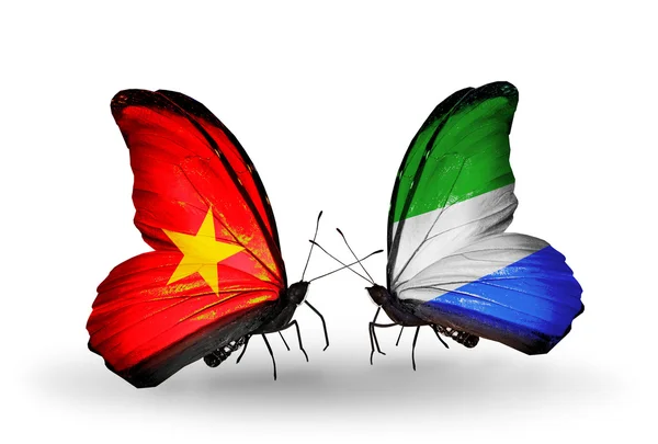 Deux papillons avec des drapeaux du Vietnam et de la Sierra Leone — Photo