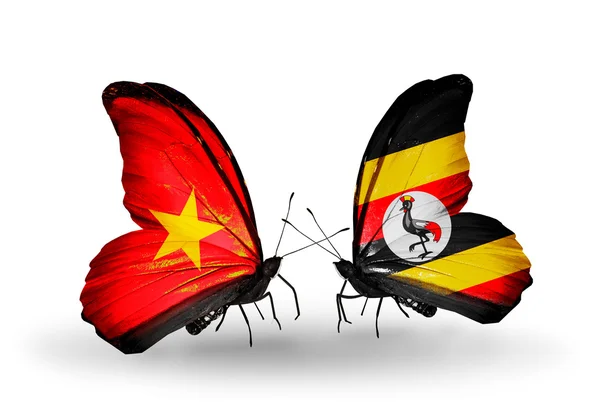 Dwa motyle z flagami i uganda — Zdjęcie stockowe