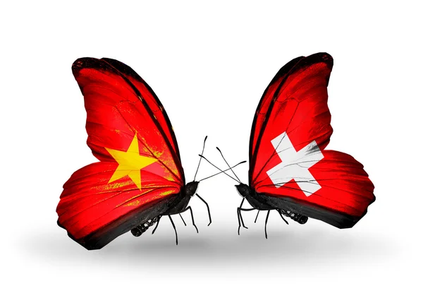 Dva motýli s příznaky Vietnamu a Švýcarsko — Stock fotografie