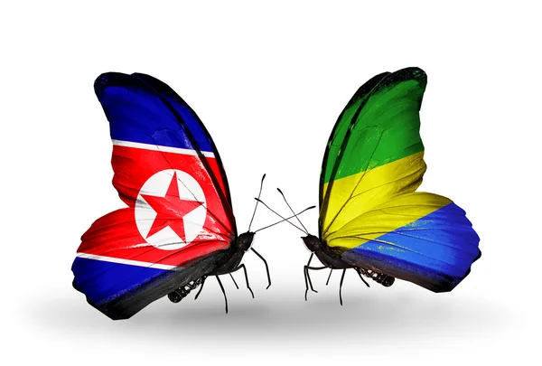Papillons avec des drapeaux de Corée du Nord et du Gabon sur les ailes — Photo
