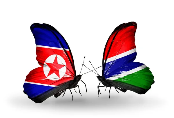 Mariposas con banderas de Corea del Norte y Gambia en alas — Foto de Stock