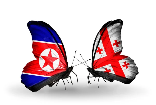 Mariposas con banderas de Corea del Norte y Georgia en alas — Foto de Stock