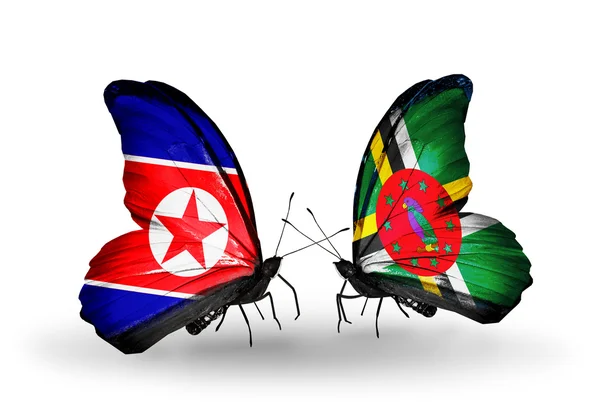 Mariposas con banderas de Corea del Norte y Dominica en alas — Foto de Stock