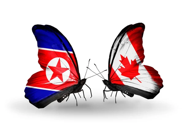 Butterflies with North Korea and Canada flags on wings — Stock Photo, Image