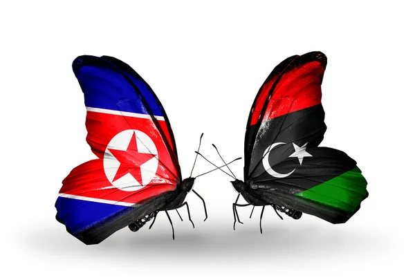 Fjärilar med Nordkorea och Libyen flaggor på vingar — Stockfoto
