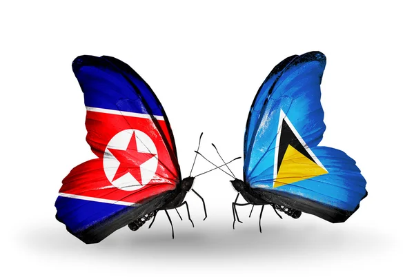 Mariposas con banderas de Corea del Norte y Santa Lucía en alas — Foto de Stock