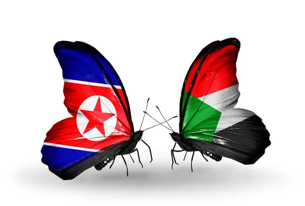 Mariposas con banderas de Corea del Norte y Sudán en alas — Foto de Stock