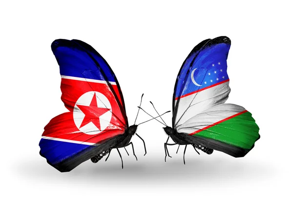 Butterflies with North Korea and Uzbekistan flags on wings — Stock Photo, Image