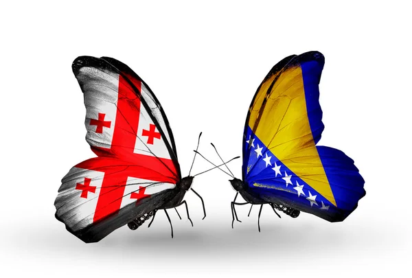 Farfalle con bandiere Georgia e Bosnia-Erzegovina sulle ali — Foto Stock