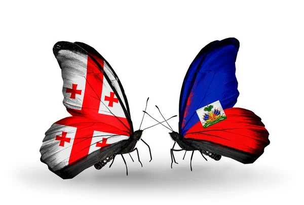 Butterflies with Georgia and Haiti flags on wings — Stock Photo, Image