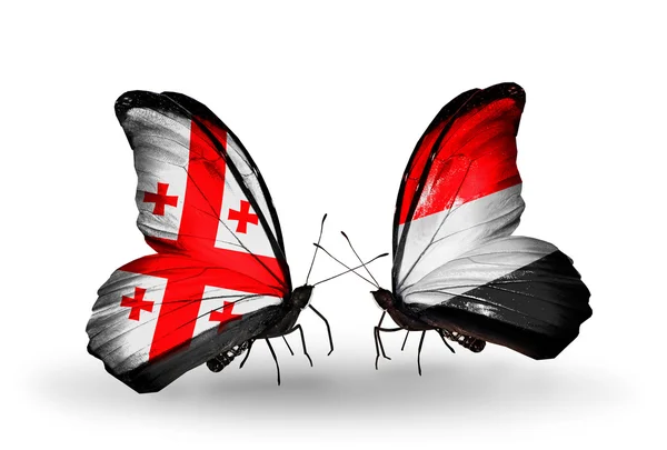 Butterflies with Georgia and Yemen islands flags on wings — Stock Photo, Image