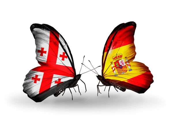 Butterflies with Georgia and Spain islands flags on wings — Stock Photo, Image