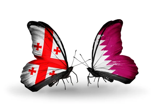 Papillons avec des drapeaux des îles de Géorgie et du Qatar sur les ailes — Photo