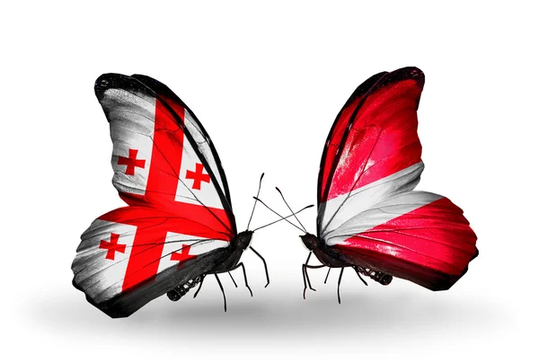 Butterflies with Georgia and Latvia islands flags on wings — Stock Photo, Image