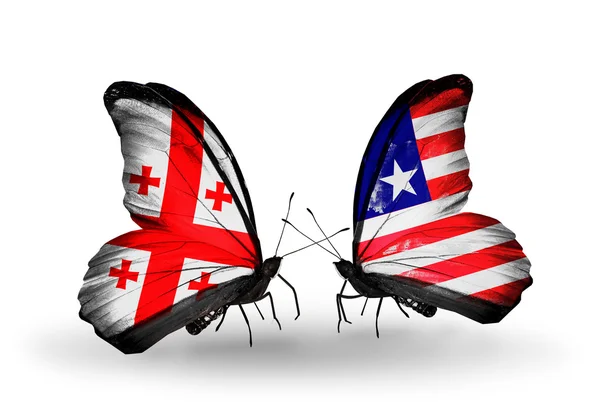 Motyle z flagi wyspy georgia i Liberii na skrzydłach — Zdjęcie stockowe