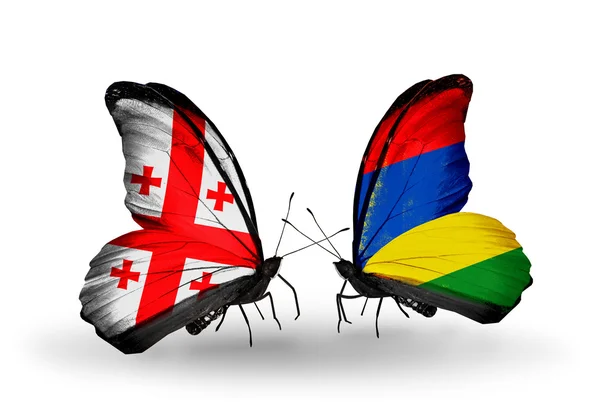 Butterflies with Georgia and Mauritius islands flags on wings — Stock Photo, Image