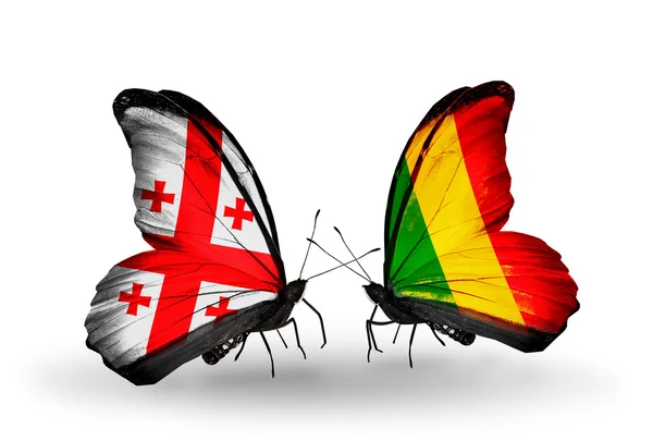 Fjärilar med Georgien och mali öarna flaggor på vingar — Stockfoto