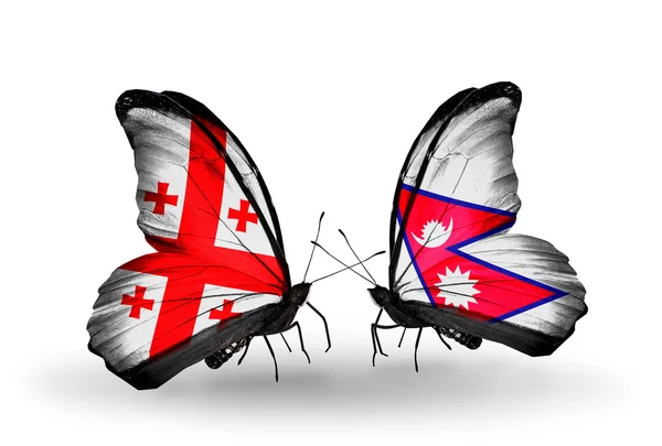 Farfalle con bandiere Georgia e Nepal sulle ali — Foto Stock