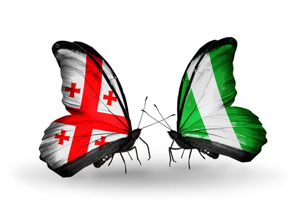 Vlinders met Georgië en nigeria vlaggen op vleugels — Stockfoto