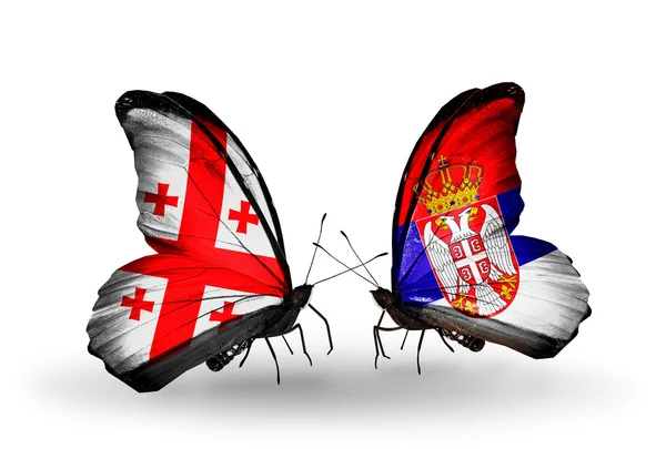 Butterflies with Georgia and Serbia flags on wings — Stock Photo, Image