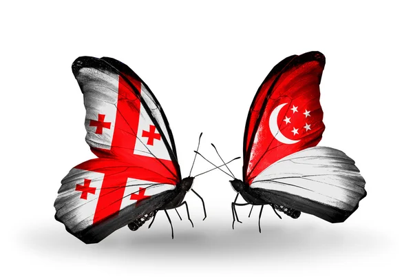 Butterflies with Georgia and Singapore flags on wings — Stock Photo, Image