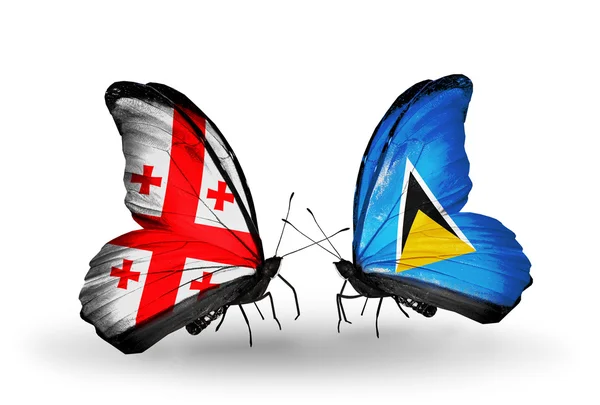 Fjärilar med Georgien och saint lucia flaggor på vingar — Stockfoto