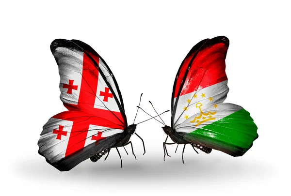 Kelebek kanatları üzerinde Gürcistan ve Tacikistan bayrağı ile — Stok fotoğraf