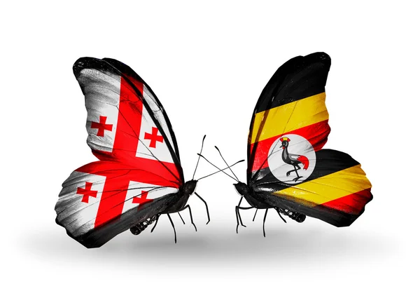 Vlinders met Georgië en Oeganda vlaggen op vleugels — Stockfoto