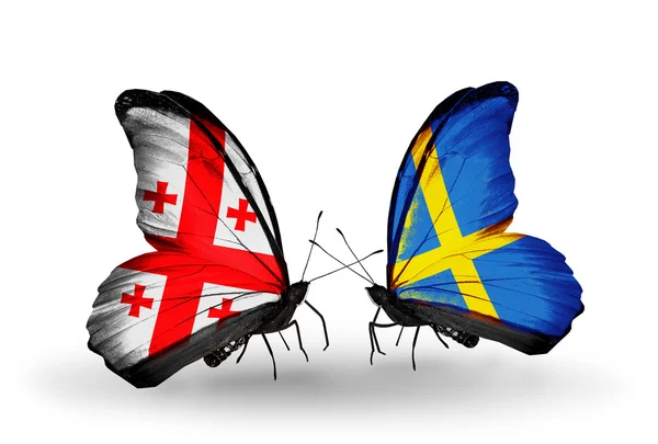 Kelebek kanatları üzerinde Gürcistan ve İsveç bayrağı ile — Stok fotoğraf