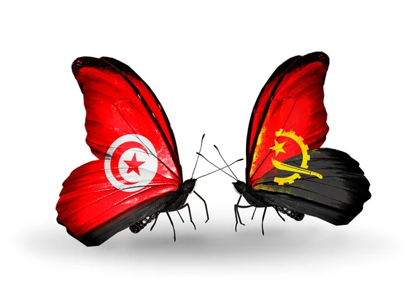 Farfalle con bandiere Tunisia e Angola sulle ali — Foto Stock