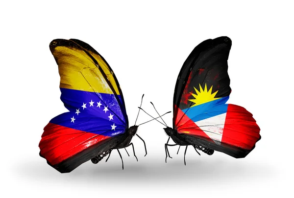 Papillons avec drapeaux Venezuela et Antigua-et-Barbuda sur les ailes — Photo