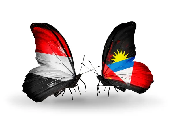 Butterflies with Yemen and  Antigua and Barbuda flags on wings — Stock Photo, Image