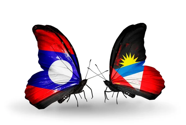 Butterflies with Laos and Antigua and Barbuda flags on wings — Stock fotografie