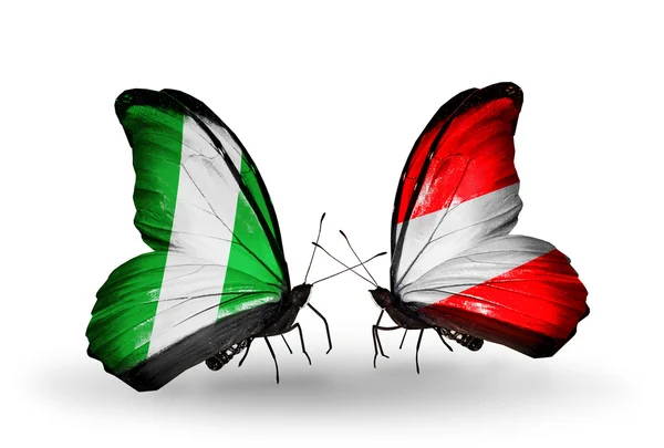 Butterflies with Nigeria and Austria flags on wings — Stock Photo, Image