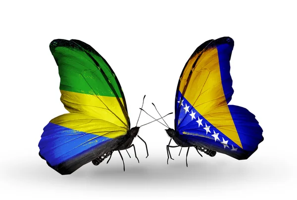 Papillons avec drapeaux Gabon et Bosnie-Herzégovine sur les ailes — Photo