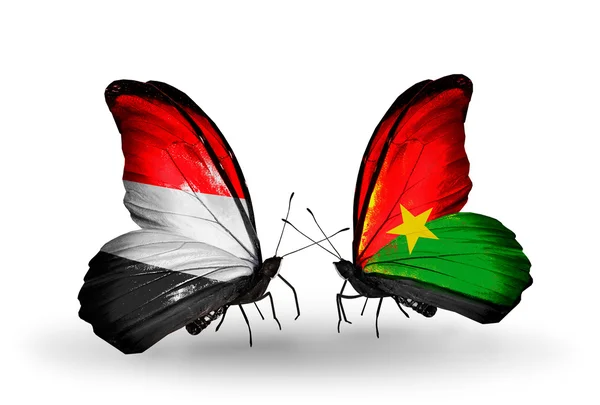 Borboletas com bandeiras do Iêmen e Burkina Faso em asas — Fotografia de Stock