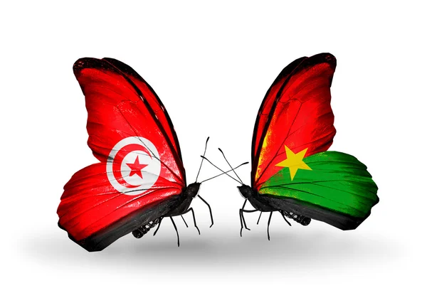 Kelebek kanatları üzerinde Tunus ve burkina faso bayraklı — Stok fotoğraf